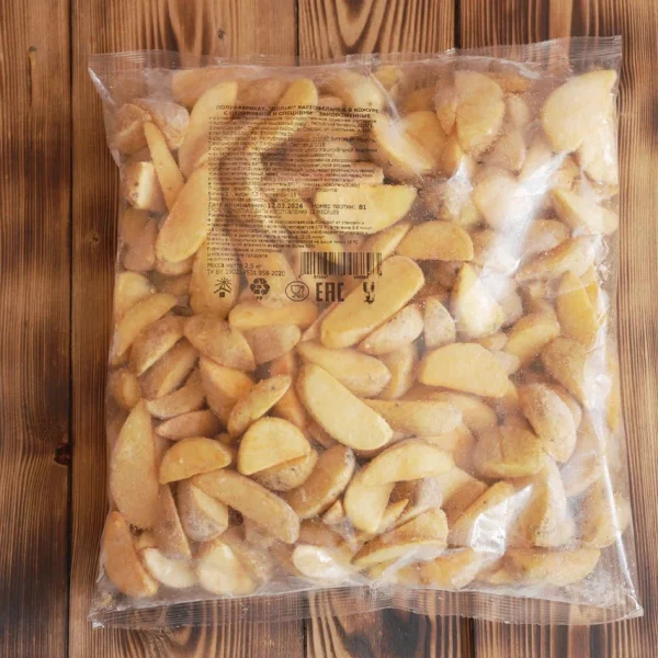 Semi-finished product. Potato wedges in their skins, breaded, and seasoned.